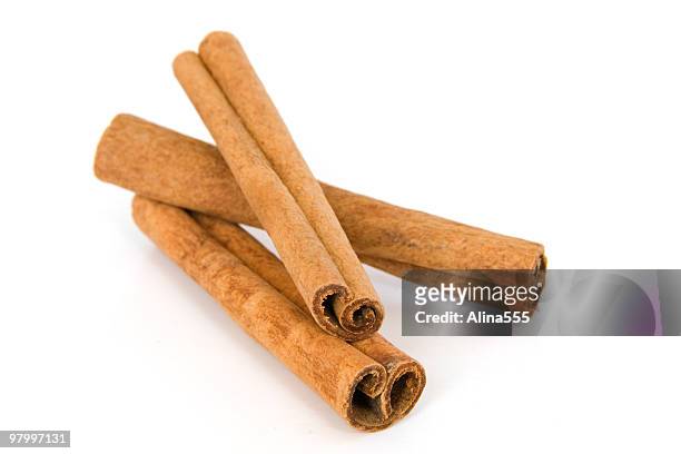 cinnamon sticks on white - cinnamon stock pictures, royalty-free photos & images
