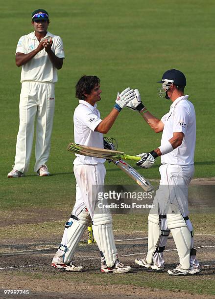 England captain Alastair Cook is congratulated by Kevin Pietersen after reaching his century during day five of the 2nd Test match between Bangladesh...