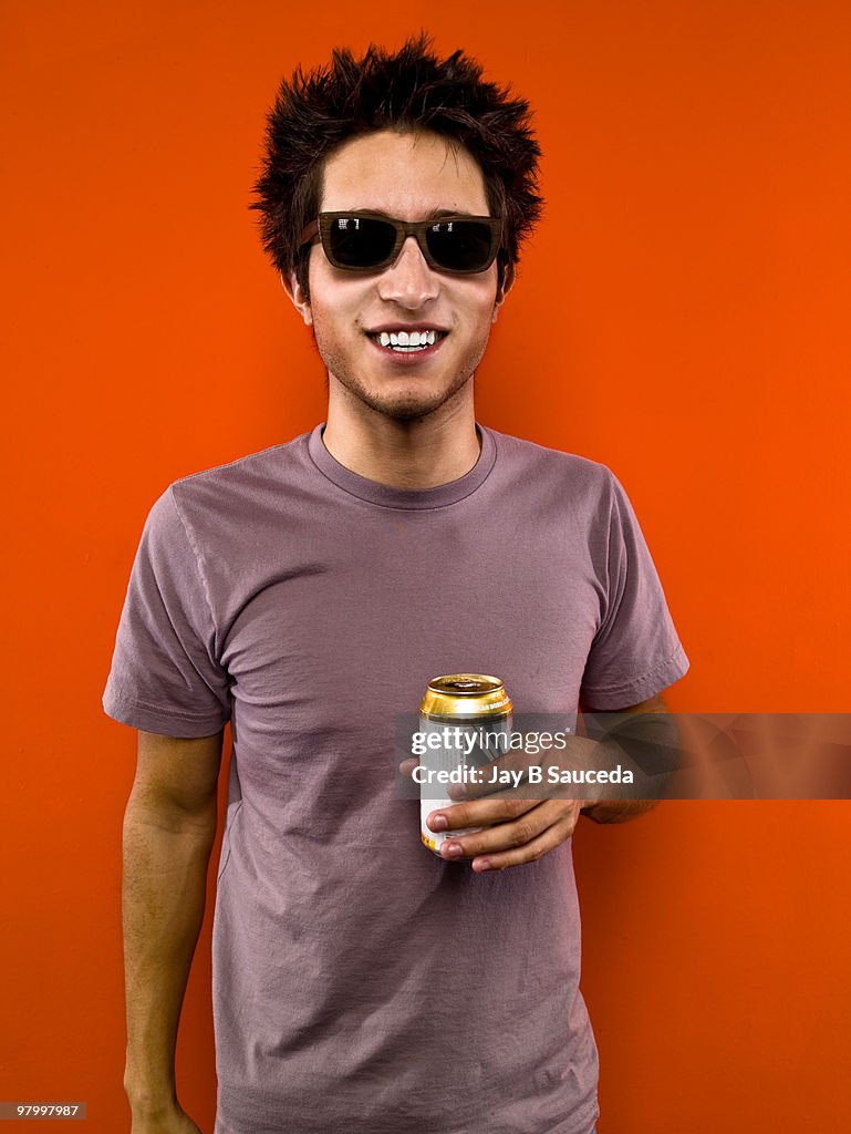 Hispanic male with glasses on orange background