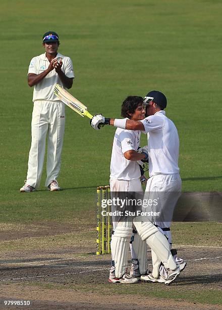 England captain Alastair Cook is congratulated by Kevin Pietersen after reaching his century during day five of the 2nd Test match between Bangladesh...