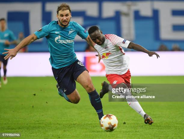 St. Petersburg's Branislav Ivanovic and Leipzig's Naby Keita vie for the ball during the UEFA Europa League round of 16 second leg soccer match...