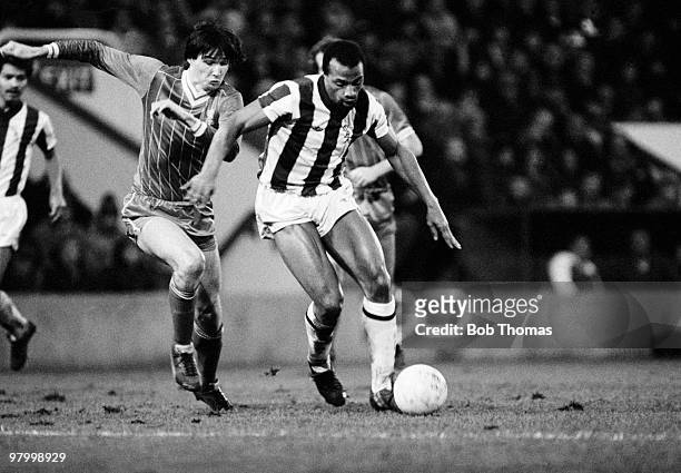 West Bromwich Albion striker Cyrille Regis is challenged by Liverpool defender Alan Hansen during their Division One league match held at The...