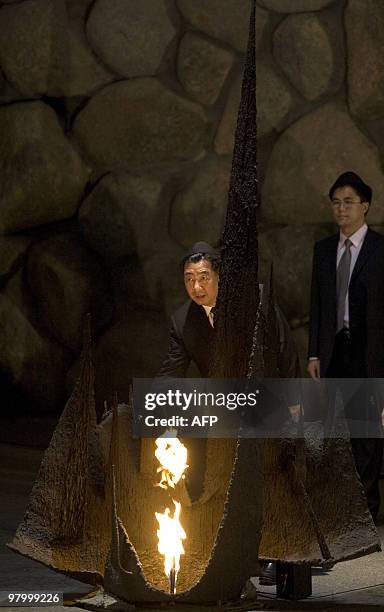 Chinese Vice Prime Minister Hui Liangyu rekindles the eternal flame in the Hall of Remembrance during his visit to the Yad Vashem Holocaust Museum in...