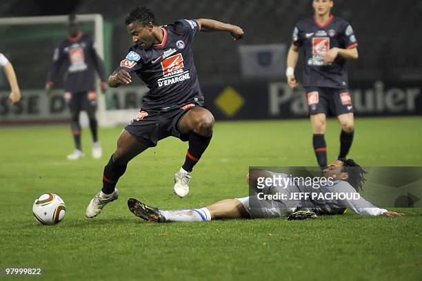 Paris' midfielder Stephane Sessegnon is tackled by Auxerre's forward Roy Contout during the French Cup football match Auxerre vs Paris Saint-Germain...
