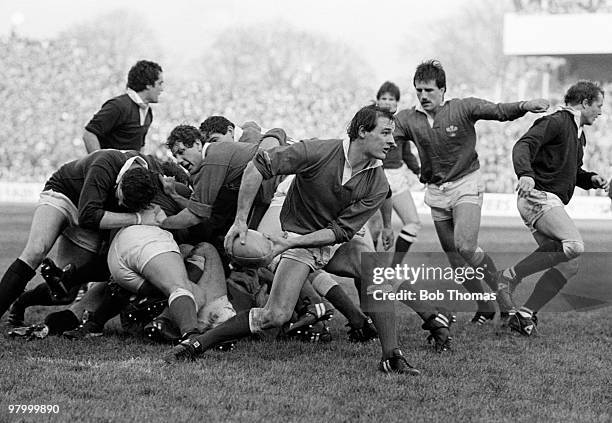 Welsh scrum-half Terry Holmes passes the ball out to the backs after a scrum during the Rugby Union International match against Scotland held at...