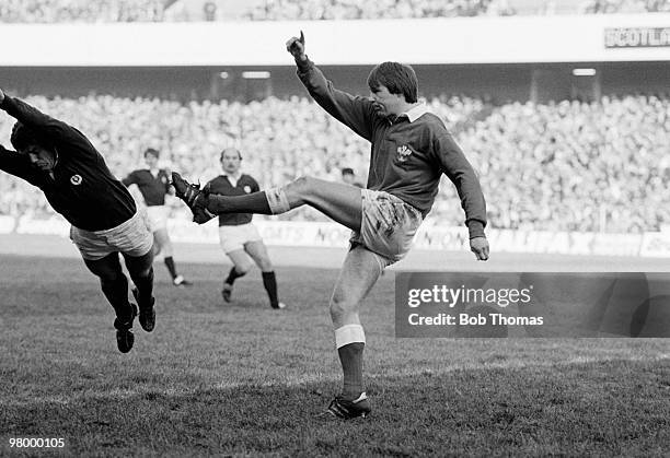 Malcolm Dacey of Wales kicks for touch before Bryan Gossman of Scotland can intercept during the Rugby Union International match held at Murrayfield,...