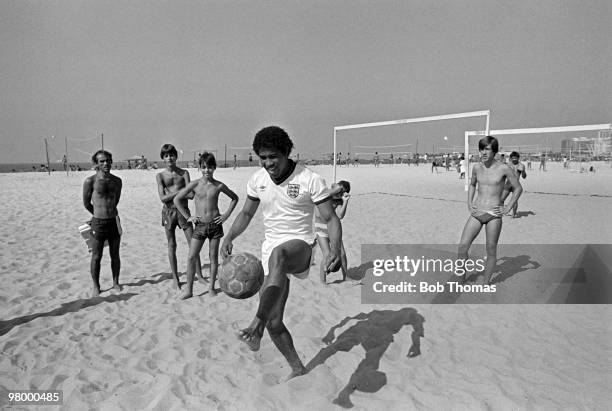 England's John Barnes shows some local children his football skills on Copacabana Beach in Rio de Janeiro, Brazil during the England Tour of South...