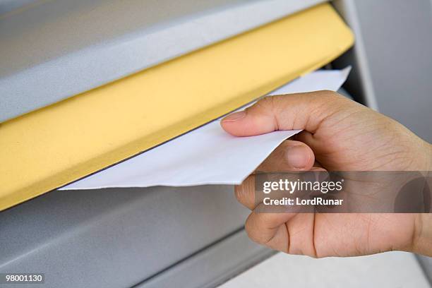 posting a letter - yellow envelope stock pictures, royalty-free photos & images