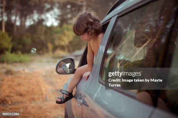 boy trying to get out of the car through the window - looking from rear of vehicle point of view stock pictures, royalty-free photos & images