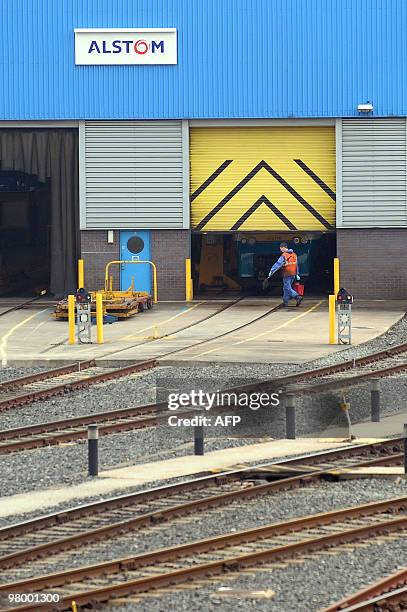 Workers are pictured outside the Alstom maintenance depot in Chester, north-west England, on March 24, 2010. Three members of the board of French...