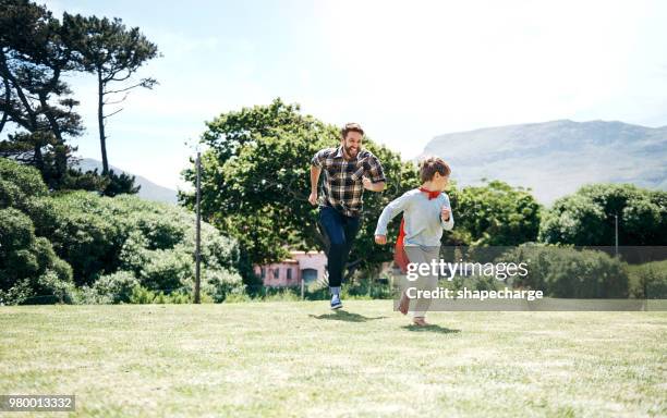 never underestimate the importance of play with your kids - superhero dad stock pictures, royalty-free photos & images
