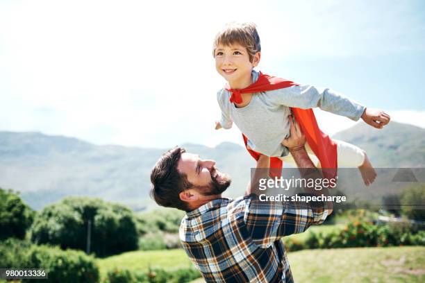 dad's always encouraging him to dream big - child superman stock pictures, royalty-free photos & images