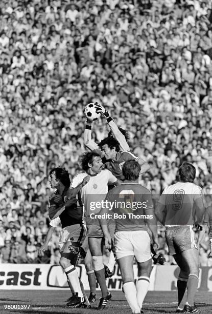 England goalkeeper Ray Clemence is supported by Trevor Brooking as he catches the ball to end a Bulgarian attack during the European Championship...