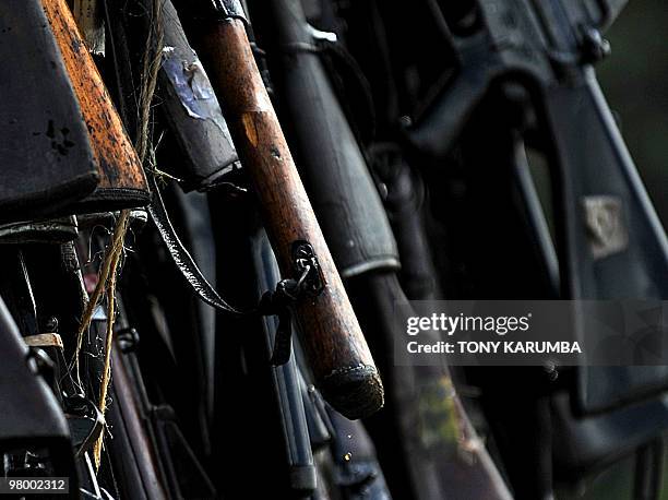 Cache of illegal fire arms drip fuel after they were doused in diesel in preparation to be burnt in Nairobi, March 24, 2010 as part of a campaign by...