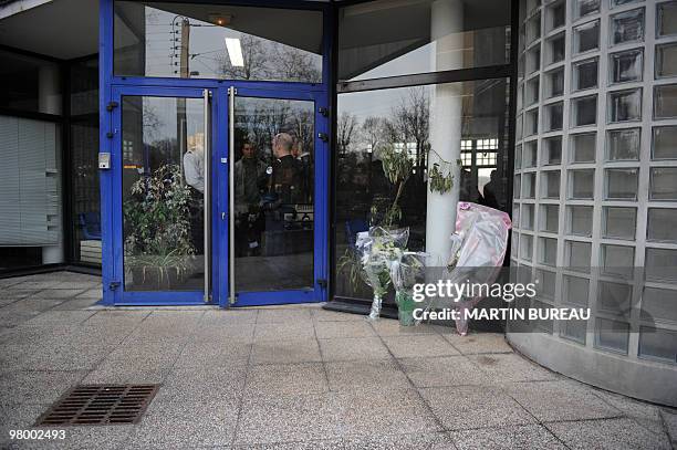 Flowers are displayed in front of a police station on March 17, 2010 in Dammarie-les-Lys, southeast suburb of Paris, during a ceremony to pay tribute...