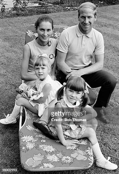 Manchester United and England footballer Bobby Charlton at home with his wife Norma and their daughters Suzanne and Andrea, in Manchester, circa 1970.
