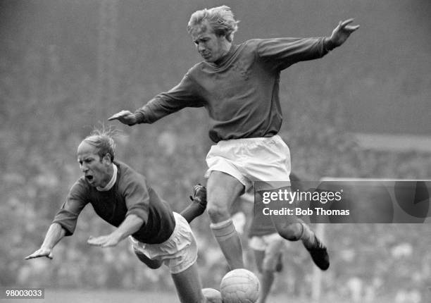 Manchester United captain Bobby Charlton falls to the ground after a challenge from Alan Birchenall of Crystal Palace during their First Division...