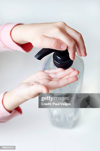 child's hands pumping a hand sanitizer bottle - crown point imagens e fotografias de stock