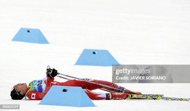 Japan's Kato Taihei lies in the snow as he competes in the men's Nordic Combined team 4x5 km at the Whistler Olympic Park during the Vancouver Winter...