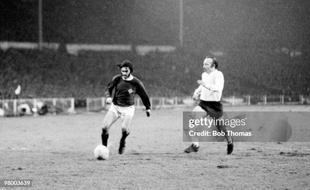George Best moves past England defender Nobby Stiles to score for Northern Ireland during the British Home International Championship match between...