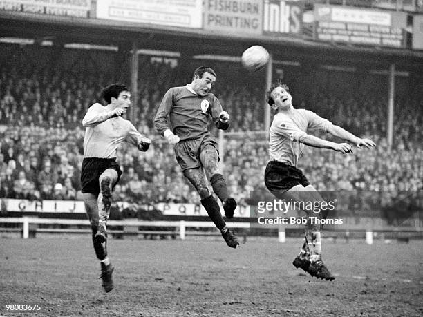 Liverpool striker Ian St John beats two Watford defenders to head the ball towards the goal during their FA Cup 3rd round match at Vicarage Road in...