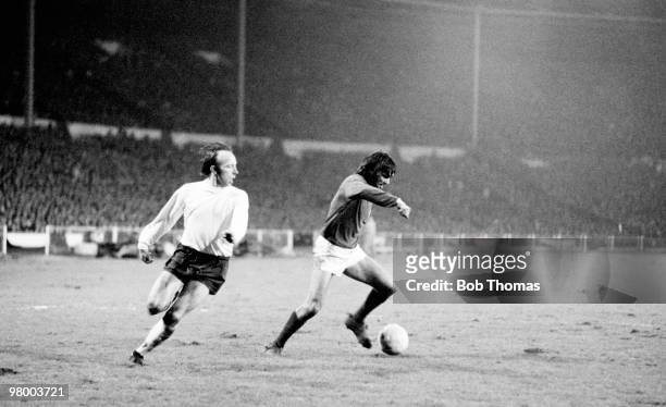 George Best moves past England defender Nobby Stiles to score for Northern Ireland during the British Home International Championship match between...