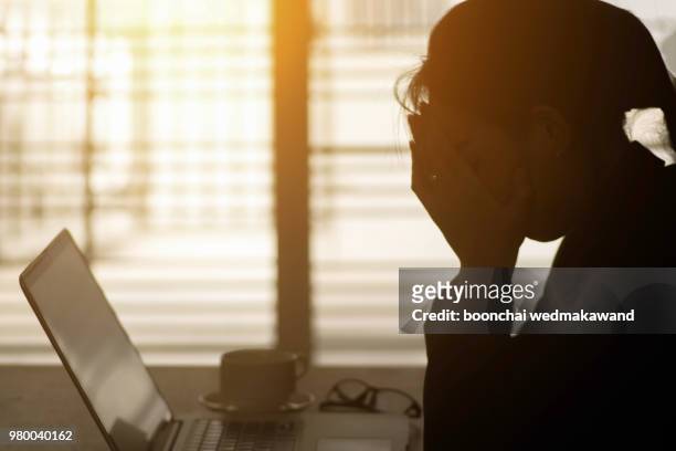 businesswoman using computer in the office. stress in the office - complaints stockfoto's en -beelden