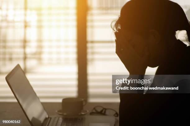 businesswoman using computer in the office. stress in the office - angry eyes stock pictures, royalty-free photos & images