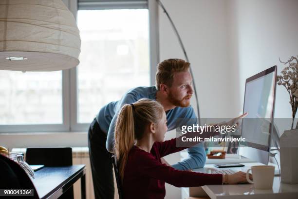 father studying with his daughter - showing tablet stock pictures, royalty-free photos & images