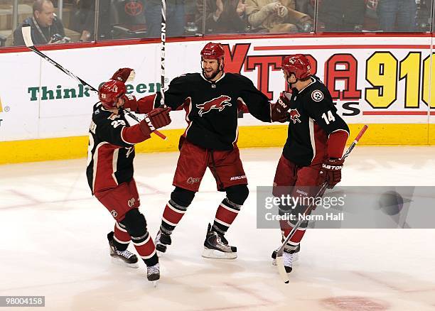 Adrian Aucoin of the Phoenix Coyotes celebrates his game tying goal against the Chicago Blackhawks with teammates Mathieu Schneider and Taylor Pyatt...