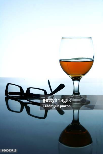 alcoholic drink and a pair of eyeglasses - merlot grape stock pictures, royalty-free photos & images