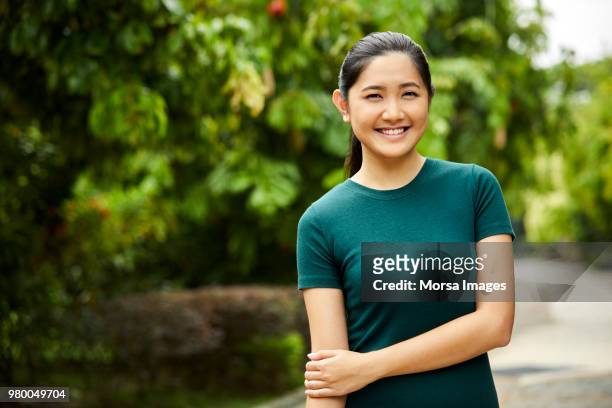portrait of young woman smiling in park - southeast asian ethnicity stock pictures, royalty-free photos & images