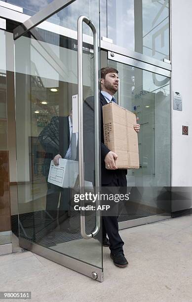 Members of the UK Serious Fraud Squad remove documents from the London office of French engineering group Alstom, on March 24, 2010. Three members of...