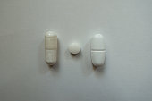 View of magnesium citrate capsule, vitamin k2 tablet and calcium citrate caplet from above