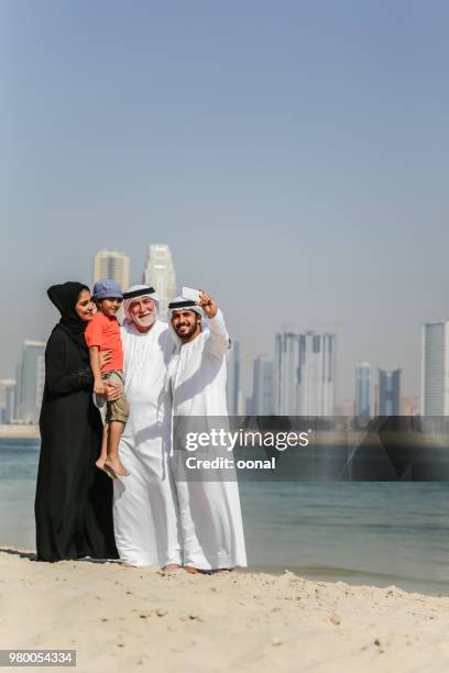 arab family taking selfie on the autumn beach - saudi grandfather stock pictures, royalty-free photos & images