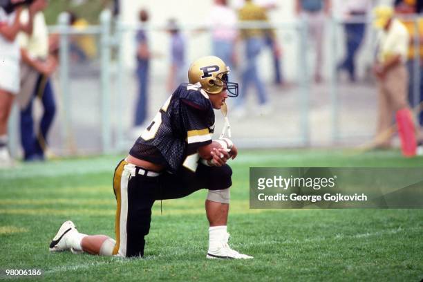Defensive back Rod Woodson of the Purdue University Boilermakers kneels during a time out during a college football game at Ross-Ade Stadium in...