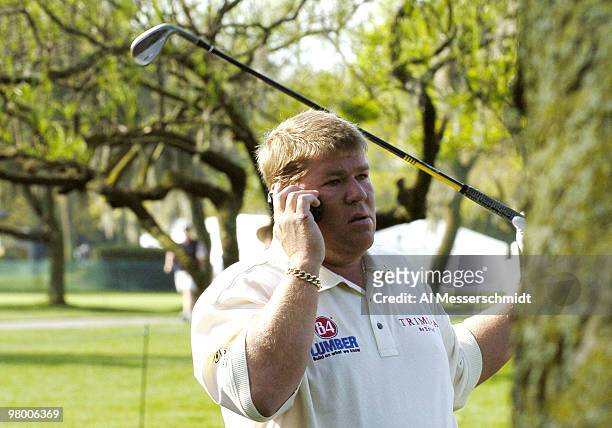 John Daly chats on his cell phone while playing the first hole during a practice round at Bay Hill Club, site of the PGA Tour Bay Hill Invitational,...