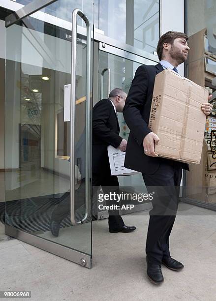 Members of the UK Serious Fraud Squad remove documents from the London office of French engineering group Alstom, on March 24, 2010. Three members of...