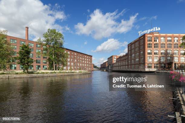 old red brick industrial buildings along the tammerkoski rapids in downtown tampere, finland on a sunny day. tampella was an industrial company operating there but nowadays it's a district of the same name. - tampere stock pictures, royalty-free photos & images