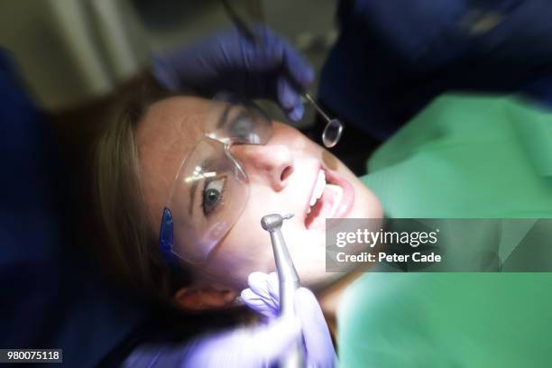 patient looking scared in dentist chair - dental drill stock pictures, royalty-free photos & images