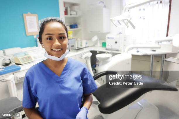 dentist stood in surgery room - sprechstundenhilfe stock-fotos und bilder