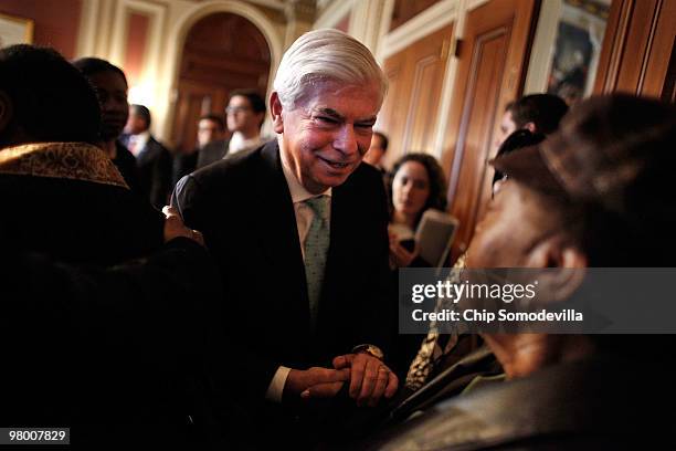 Senate Banking and Urban Affirs Committee Chairman Christopher Dodd greets members of the AARP after a rally and news conference about the benefits...