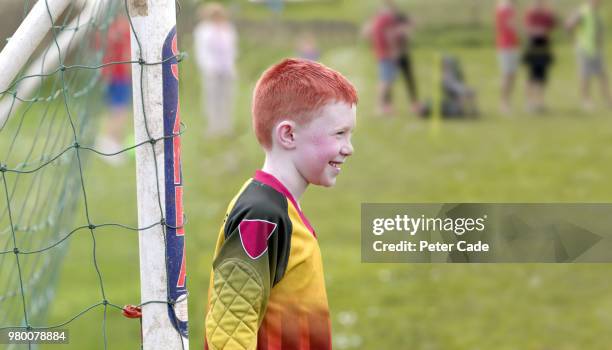 boy in goal at football game - redhead boy stock pictures, royalty-free photos & images