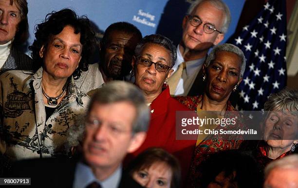 Members of the Association of American Retired Persons stand behind Senate Finance Committee Chairman Max Baccus during a news conference and rally...