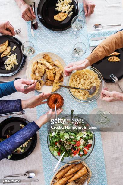 group of senior friends eating dinner together at home. top view. - pasta overhead stock pictures, royalty-free photos & images