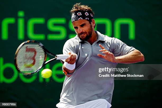 Arnaud Clement of France returns a shot against Guillermo Garcia-Lopez of Spain during day two of the 2010 Sony Ericsson Open at Crandon Park Tennis...