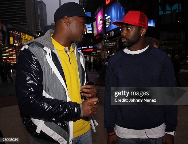 Players Shaun Phillips and Darrelle Revis film an Earth Day E campaign in Times Square on March 23, 2010 in New York City.