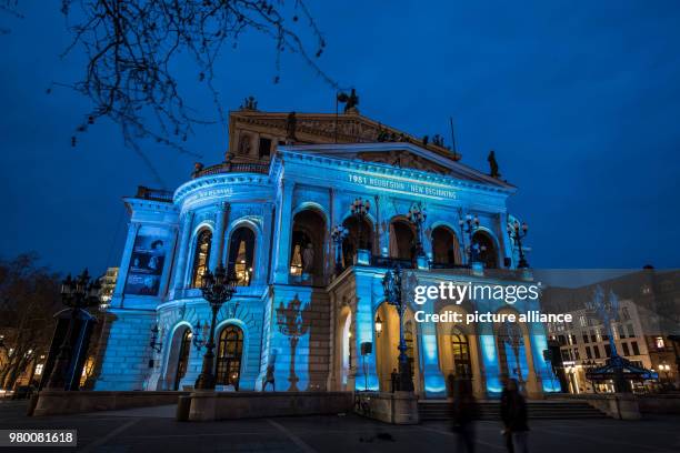 March 2018, Germany, Frankfurt: The fasade of the Alte Oper opera house shines in bvright colourful light as part of a visual spectacle during the...