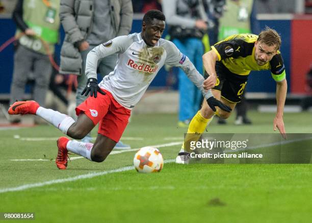Dortmund's Marcel Schmelzer and Salzburg's Diadie Samassekou vie for the ball during the UEFA Europa League round of 16 second leg soccer match...