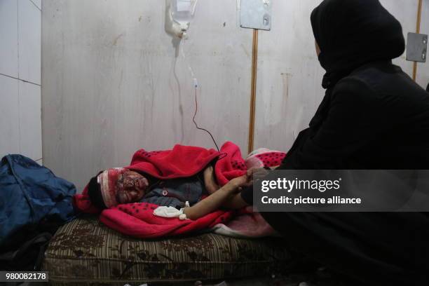 Dpatop - A Syrian boy receives first aid in a makeshift hospital after he was injured during air strikes by forces loyal to Syrian President Assad in...